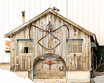 Old Wooden Barn with Tools Hanging on it Editorial Stock Photo