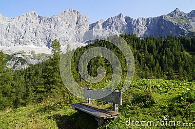 a wooden bench in the Austrian Alps in the Dachstein region (Austria) Stock Photo
