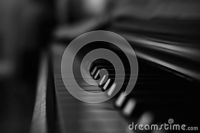 Old and wooden black and white piano keyboard in darknes with music Stock Photo