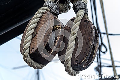 Old wooden block pulleys and rope Stock Photo