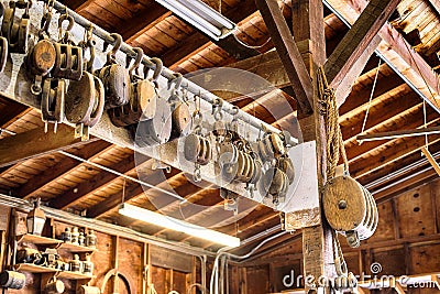 Old wooden Block and tackle pulleys in a boat builders shop Stock Photo