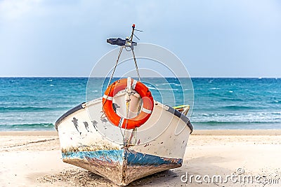 Old wooden boat on the Mediterranean sea with a life-saving circle on its nose Stock Photo