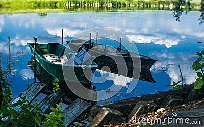 Old wooden boats on the shore of a marshy river. Rustic landscape of Louisiana, USA Stock Photo