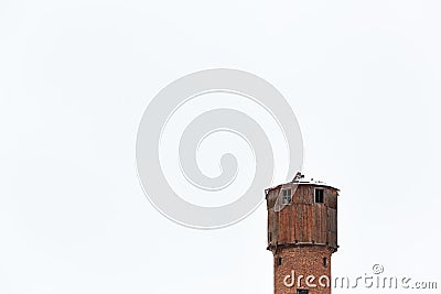 An old wooden and brick water firestation orange rural tower. Isolated on a clear white sky background Stock Photo