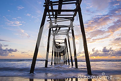 Old wooden bridge in Natai beach with beautiful sky at twilight Stock Photo