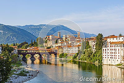 Old wooden bridge spans the river brenta at the romantic village Basano del Grappa, Italy Stock Photo