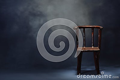 Old wooden chair on dark scene Stock Photo