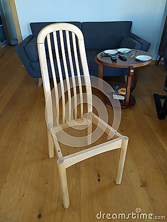 Old wooden chair without seat after repairing with lime and wood clamps Editorial Stock Photo