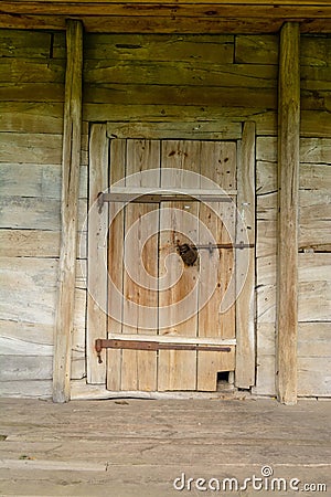 Old wooden door in the ancient structure of the boards. Secret or hidden information. Stock Photo