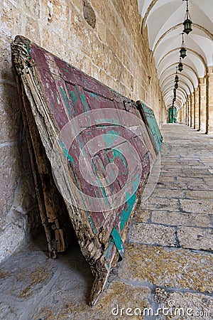 An old wooden door lies against a wall in a tunnel along the west wall on the Temple Mount, in the old city of Jerusalem, in Stock Photo