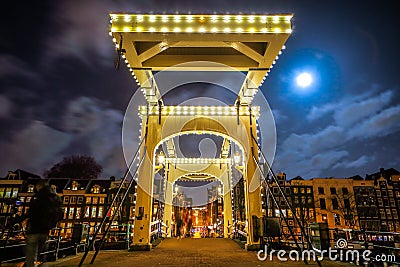 Old wooden Dutch bridge at night time against rush clouds. Editorial Stock Photo