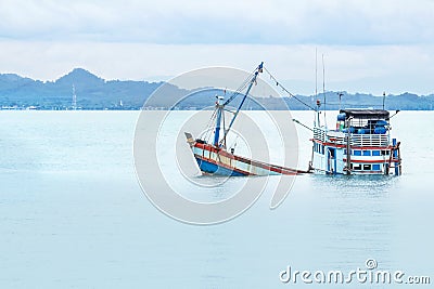 Old wooden fishing boat shipwreck submerged in the sea Stock Photo