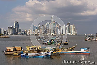 Old wooden fishing boats in front of the skyline of panama city panama Editorial Stock Photo