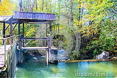 Old wooden floodgate at a small river Stock Photo