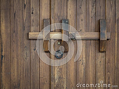Old wooden gate closed with a big bolt Stock Photo