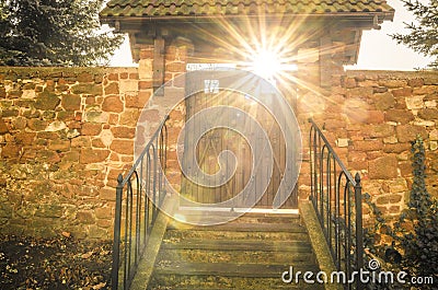 Old wooden gate with sun rays shining through Stock Photo