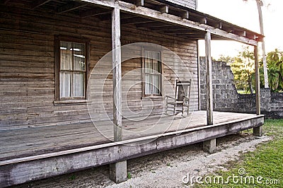 Old wooden home with rocking chair Stock Photo