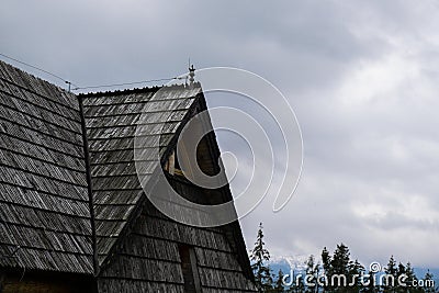 Old wooden house in Snowy mountains, green forests In National park Zakopane Poland. Mountain nature landscape. Blue sky Stock Photo