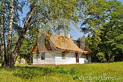 Old wooden house with straw roof Stock Photo