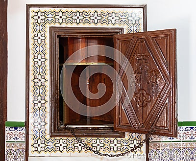 Old wooden lathe giratory to pass objects from one part to another in a cloistered convent Stock Photo