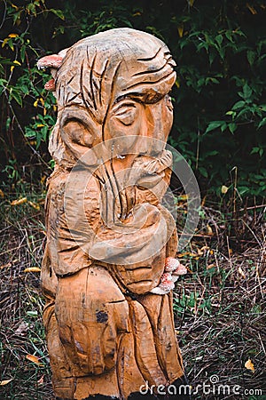 Old wooden pagan idol in the park Stock Photo