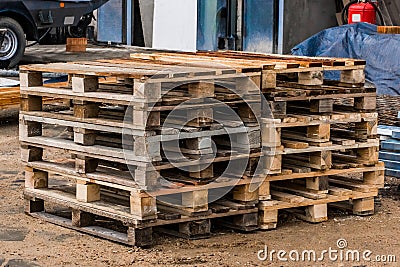 Old wooden pallets storage on warehouse at a construction site, close-up Stock Photo