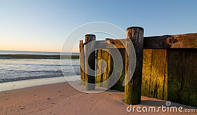 Old wooden pier on beach Stock Photo