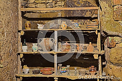 Old wooden shelf with vintage pottery in house of the ancient abandoned village Celleno, Viterbo, Lazio, Italy Editorial Stock Photo