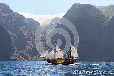 Old wooden ship with white sails Stock Photo