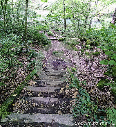 Old wooden staircase. Floor covered with litter along the river Stock Photo