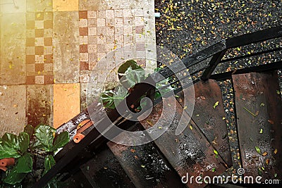 Old wooden stairs View from top view Wet from the rain And tile flooring. Stock Photo