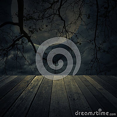 Old wooden table over dead tree, Halloween background Stock Photo