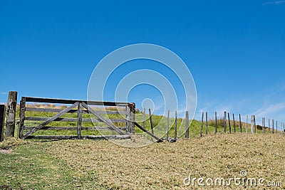 Old wooden timber gate and fence in rural New Zealand, NZ Stock Photo