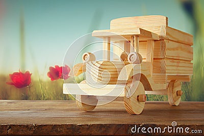 Old wooden toy car over wooden table. nostalgia and simplicity concept. vintage style image Stock Photo