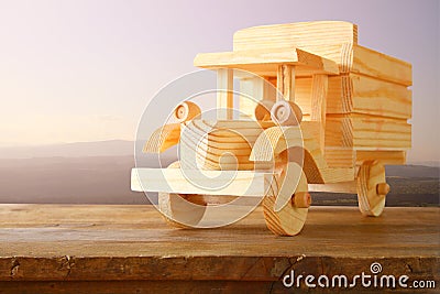 Old wooden toy car over wooden table. nostalgia and simplicity concept. vintage style image Stock Photo