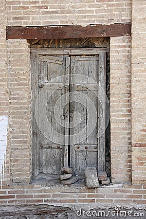 Old wooden tumbledown door in the Central Asian style Stock Photo