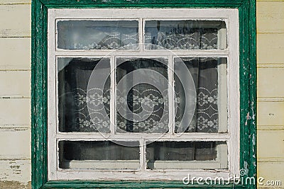 Old wooden window with peeled paint on a bright day Stock Photo