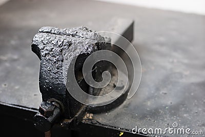 Old workbench in the welding room. Vise for a welder in a workshop. Place - old workshop. Stock Photo