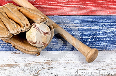 Old worn baseball equipment on faded boards painted in American Stock Photo