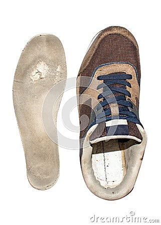 An old worn sneaker insole on a white background. Stock Photo