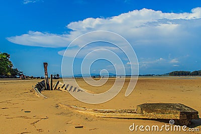 Old wreck fishing boat buried in the sand with blue sky on cloud Stock Photo