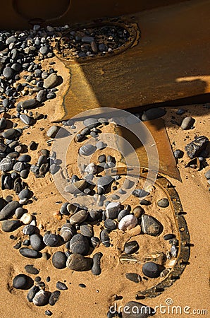 Wrecked boat hatches buried in the beach sand Stock Photo