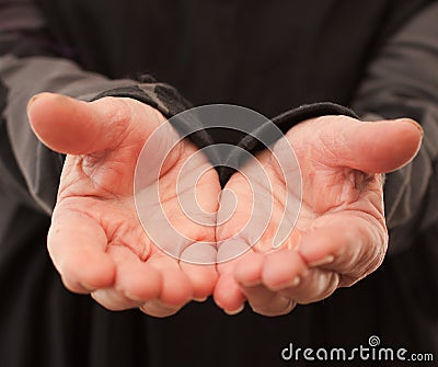 Old wrinkled hands offering something Stock Photo