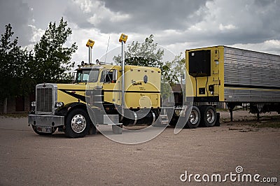 Old yellow Peterbilt truck parked in the open field in Kingman, US Editorial Stock Photo