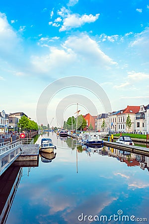OLDENBURG, GERMANY - MAY 24, 2019: Boats drop anchor in a haven. Vertical Editorial Stock Photo