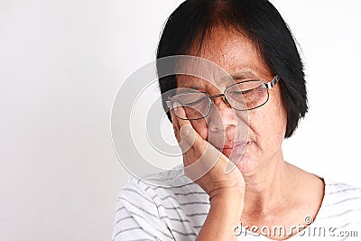 Older Asian women are sad because of toothache. Stock Photo