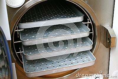 Older autoclave chamber with stainless shelves Stock Photo