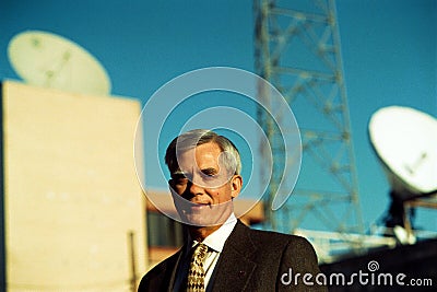 Older Businessman & Satellite Communication Dishes Stock Photo