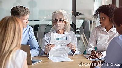 Older company executive presenting financial report result at team meeting Stock Photo