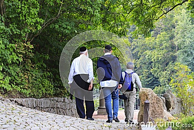 Older Hasidic Jews walk in the park during the Jewish New Year in Uman, Ukraine. Religious Jew Editorial Stock Photo